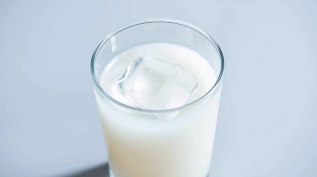 A glass of milk with ice in it photo