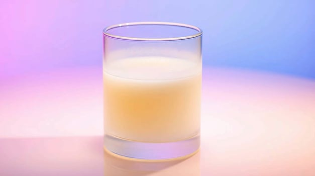 A glass of milk on a colorful background photo
