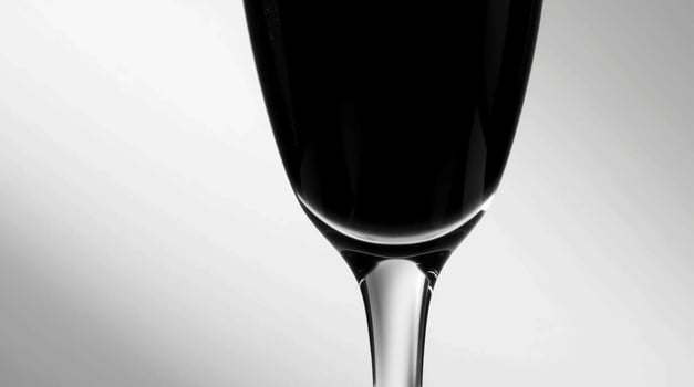 A black and white photo of a glass of champagne
