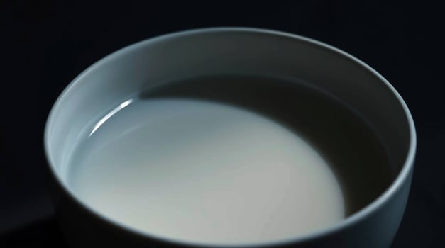 A white cup with milk in it photo