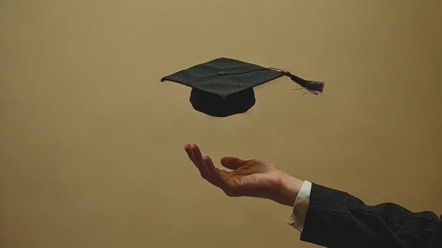 Graduation cap tossed in air by hand celebrating academic achievement and future success photo