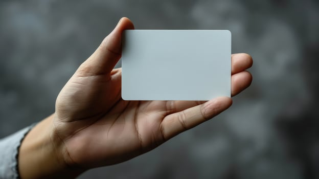 Blank card in hand for business mockup template on gray background photo