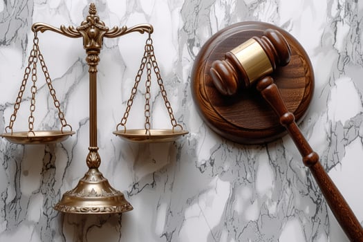 Golden balance scale and wooden gavel representing justice and legal system photo