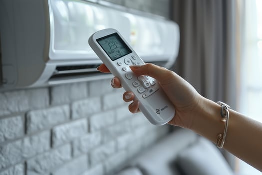 Air conditioner adjustment with digital remote control for home climate comfort photo