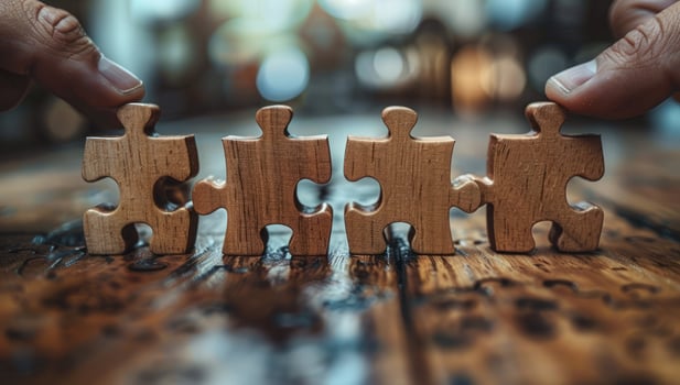 Wooden jigsaw puzzle pieces connecting strategy and teamwork business concept photo