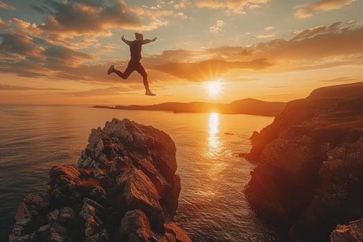 Person leap between cliffs during sunset adventure travel photo