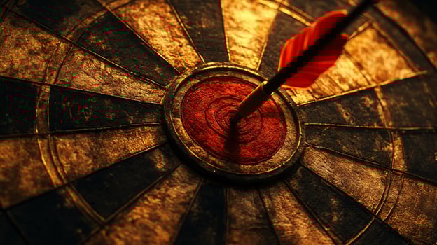 A dart is in the center of a target photo