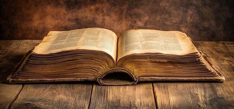 An old book on a wooden table photo