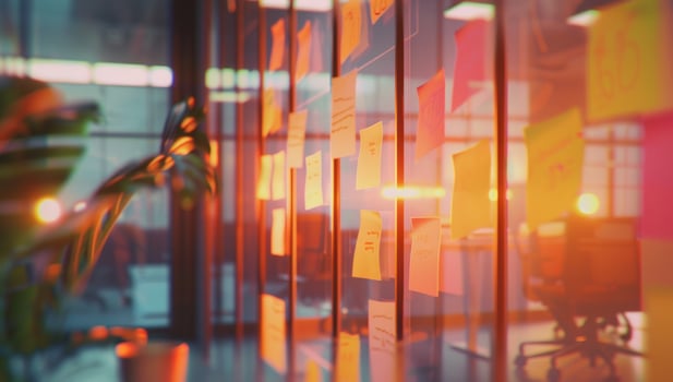 Glass wall with sticky notes in bright modern office for team brainstorming photo