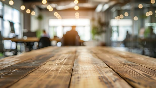 Wooden desk surface with blurred office background business and workspace concept photo