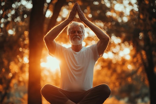 An older man is doing yoga in the sun photo