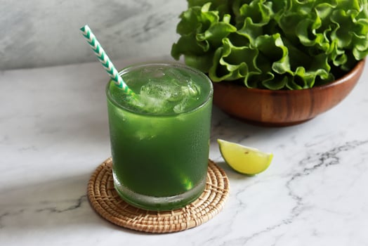 Green vegetable juice glass with fresh veggie for healthy drinking conceept photo