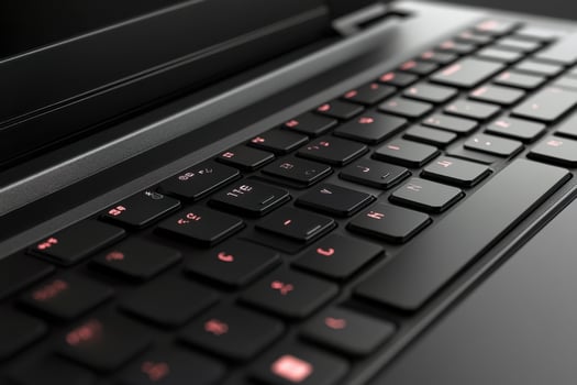 A close up of a laptop with a red keyboard photo