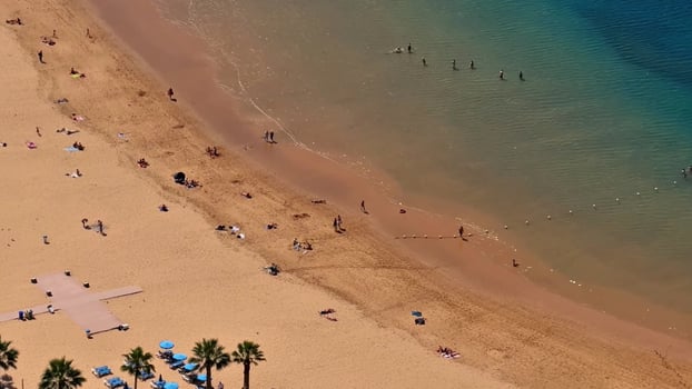 Experience the Breathtaking Aerial View of a Truly Vibrant and Beautiful Beach Scene photo
