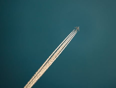 A jet plane flying through the sky with contrails photo