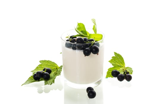 sweet homemade yogurt with black currant on white background. photo