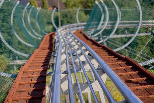 Curved roller coaster track viewed from a low angle in an amusement park photo