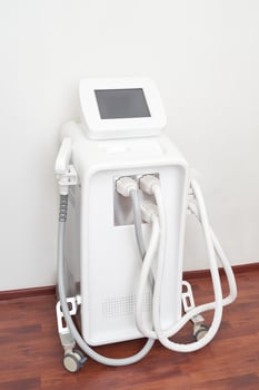 Cryolipolysis machine on wheels with display screen in a clinic setting for non-invasive fat reduction treatment. photo