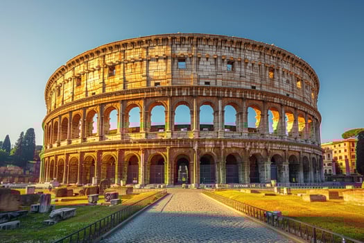 The Colosseum in Rome, Italy, with golden sunlight illuminating the ancient Roman amphitheater. photo