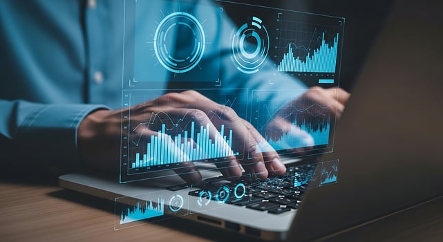 Hands typing on a laptop with futuristic glowing data analytics graphs and charts overlay symbolizing digital technology and financial growth photo