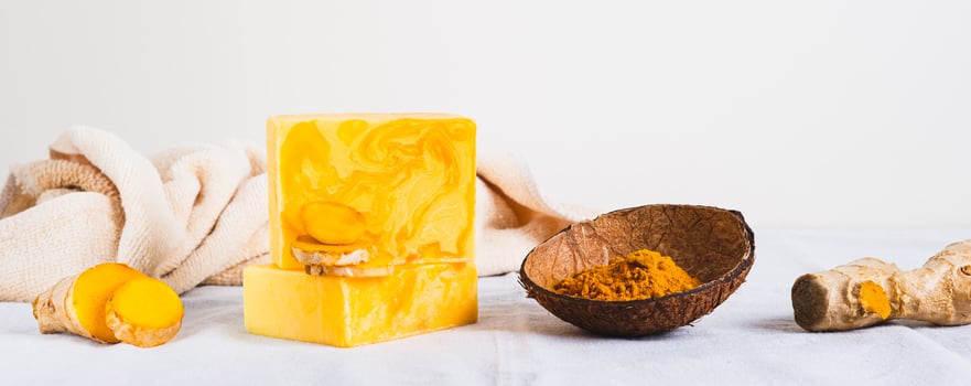 Natural homemade rejuvenating soap with turmeric on the table web banner photo