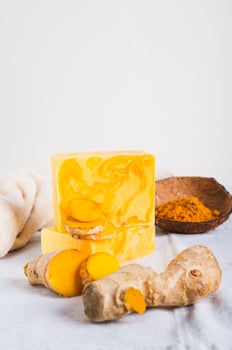 Natural homemade rejuvenating soap with turmeric on the table vertical view photo