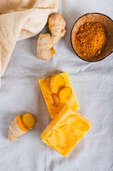 Organic Moisturizing Turmeric Soap Bars on Table top and vertical view photo