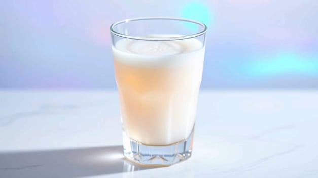 A glass of milk with a white liquid in it photo