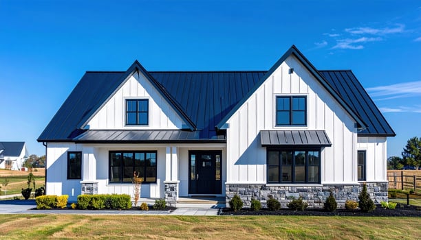 A white farmhouse with black metal roof photo