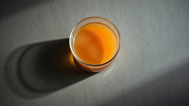 An orange juice in a glass on a table photo