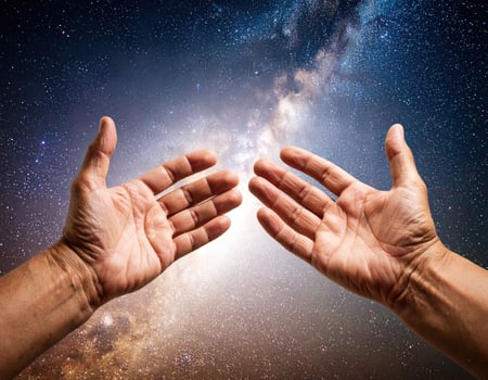 Reaching hands with weathered and calloused skin extend towards vast expanse of universe, symbolizing hope and connection to cosmos photo