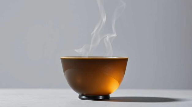A brown cup with smoke coming out of it photo