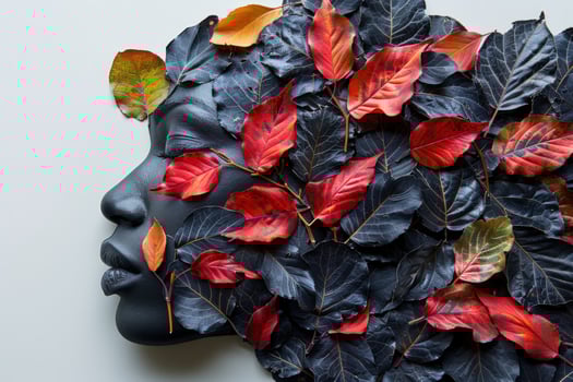 Black and white face with autumn leaves as hair. photo