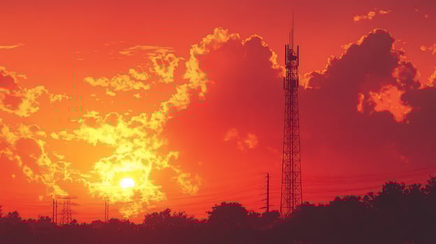 Fiery sunset with telecommunication tower silhouette. photo