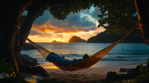 Person sleeping in hammock on beach at sunrise. photo