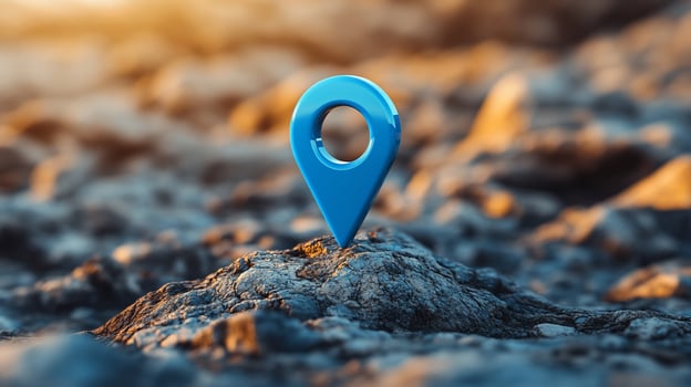 Blue location pin on rocky terrain at sunset. photo