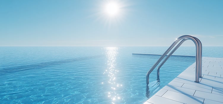 Tranquil infinity pool scene with bright sunlight reflecting on the water. photo