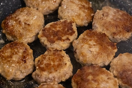 Homemade juicy meat patties frying in a pan with sizzling oil, golden brown crust, and tender texture. Traditional home cooking, comfort food, delicious meal preparation and homemade cuisine photo