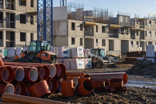 Wroclaw, Poland, January 18, 2025. Construction site with heavy machinery, building materials and concrete structures under development. Industrial scene, pipes, and ongoing urban development photo