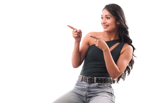 Asian Girl Curiously Looking Sideways And Pointing Left photo
