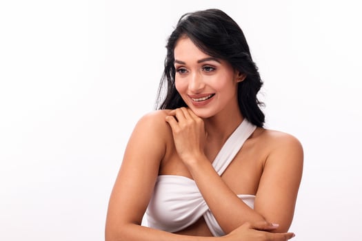 Attractive Young Woman Posing Against A White Studio Background photo