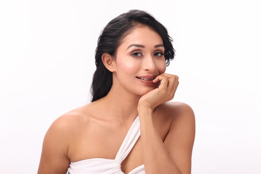 Beautiful Young Woman Smiling With Her Hand On Her Chin photo
