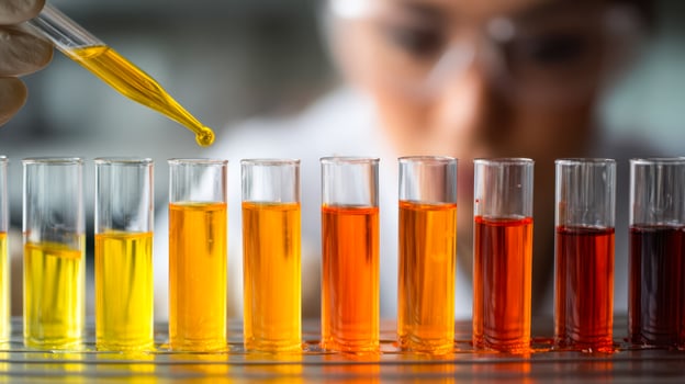 Laboratory scientist conducting a colorimetric test with diverse liquid solutions photo