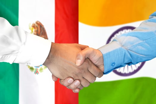 handshake on Mexico and India flag background. photo