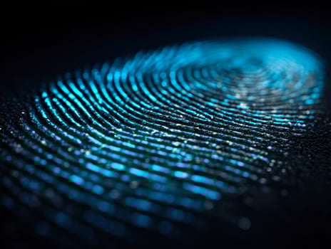 Close-up of a luminous fingerprint pattern on a dark surface photo