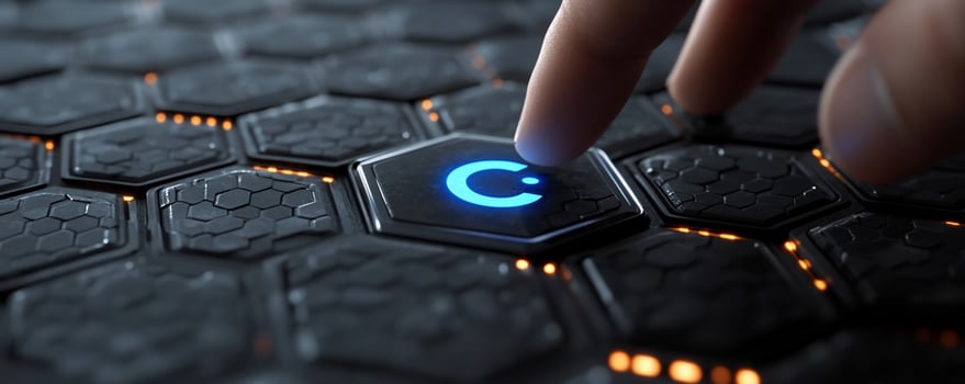 Finger presses glowing power button on futuristic hexagonal interface. photo