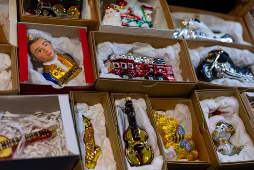 Close-up of various colorful vintage Christmas tree glass ornaments displayed in boxes. Concept of festive holiday decorations, collectible ornaments, and Christmas preparation. photo