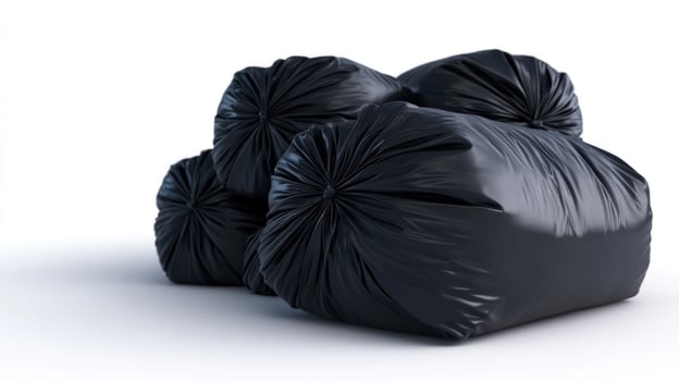 Pile of Black Garbage Bags on White Background photo