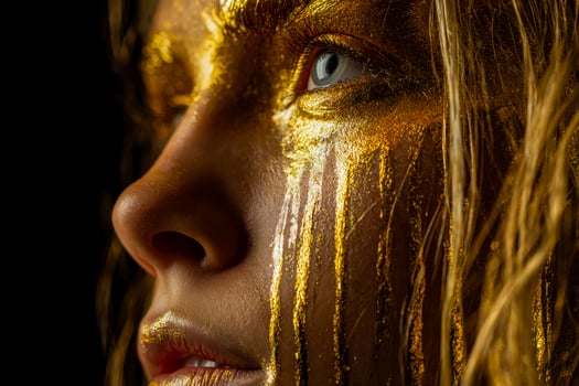 Golden elegance close up of a womans face adorned with shimmering gold paint photo