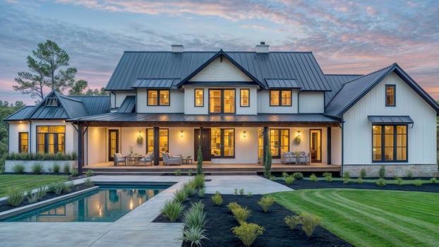 A large house with a pool and a porch. The house is surrounded by a lush green lawn photo